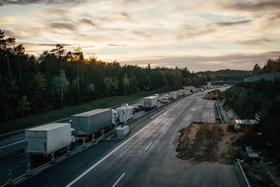 High angle view of vehicles on road in city at sunset