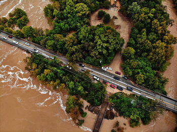 High angle view of bridge over road by trees