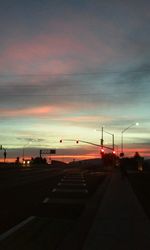 Road against cloudy sky at sunset
