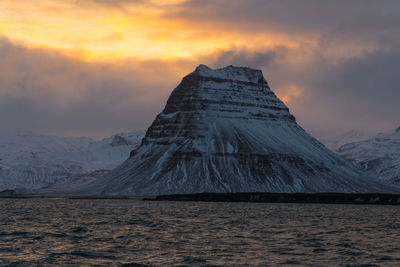 Scenic view of snowcapped mountain against sky during sunset