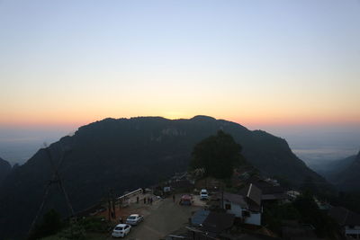 High angle view of buildings and mountains against clear sky