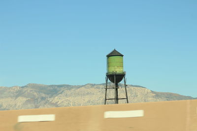 Low angle view of water tower against clear sky