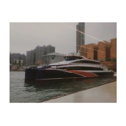 Digital composite image of buildings and river against sky