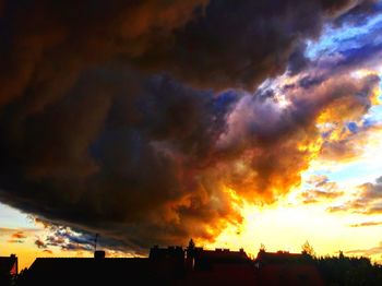 Silhouette of building against dramatic sky