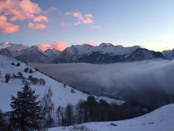 Scenic view of snowcapped mountains against sky at sunset