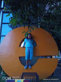 Portrait of smiling boy standing against plants