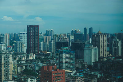 High angle view of modern buildings in city against sky