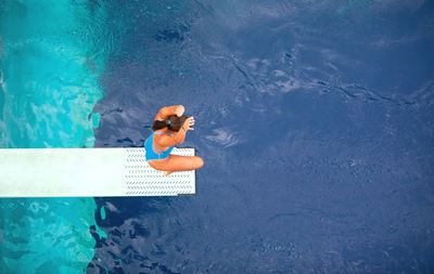 High angle view of woman swimming in pool