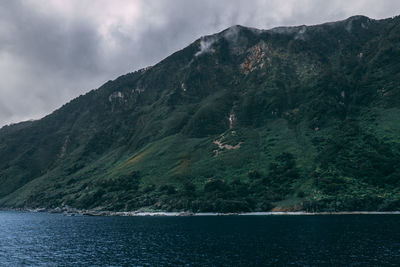 Scenic view of bay against mountains