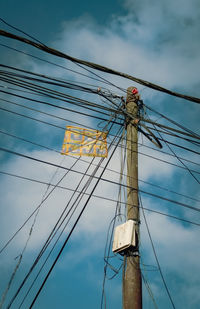 Low angle view of electricity pylon against sky