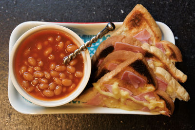 High angle view of beans with bread served on table