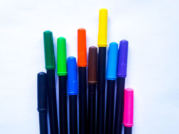 Close-up of colored pencils over white background