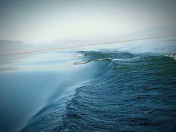 Scenic view of sea with mountains in background