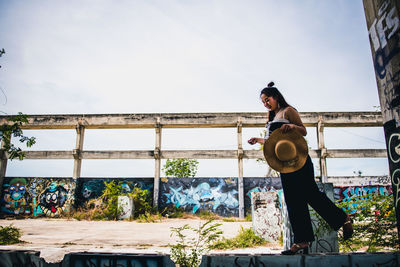 Man standing against built structure against sky