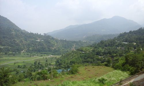 Scenic view of landscape and mountains against sky