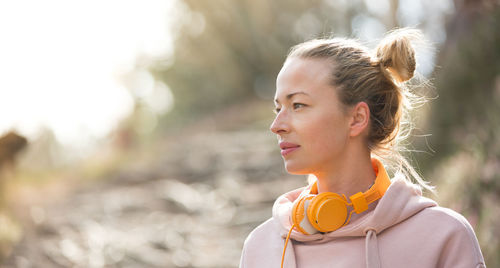 Portrait of young woman looking away outdoors