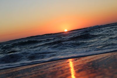 Scenic view of sea against clear sky during sunset