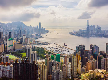 Panoramic view of city buildings against cloudy sky