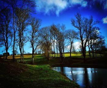 Scenic view of river against cloudy sky