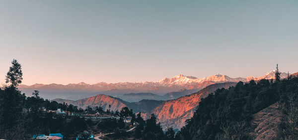 Scenic view of mountains against clear sky during sunset