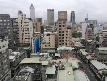 High angle view of buildings in city against sky