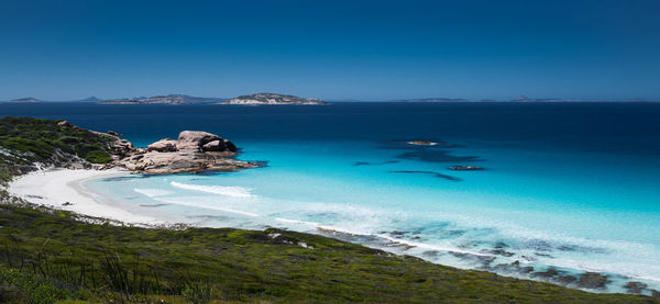 Scenic view of sea against clear blue sky