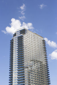 Low angle view of modern building against blue sky