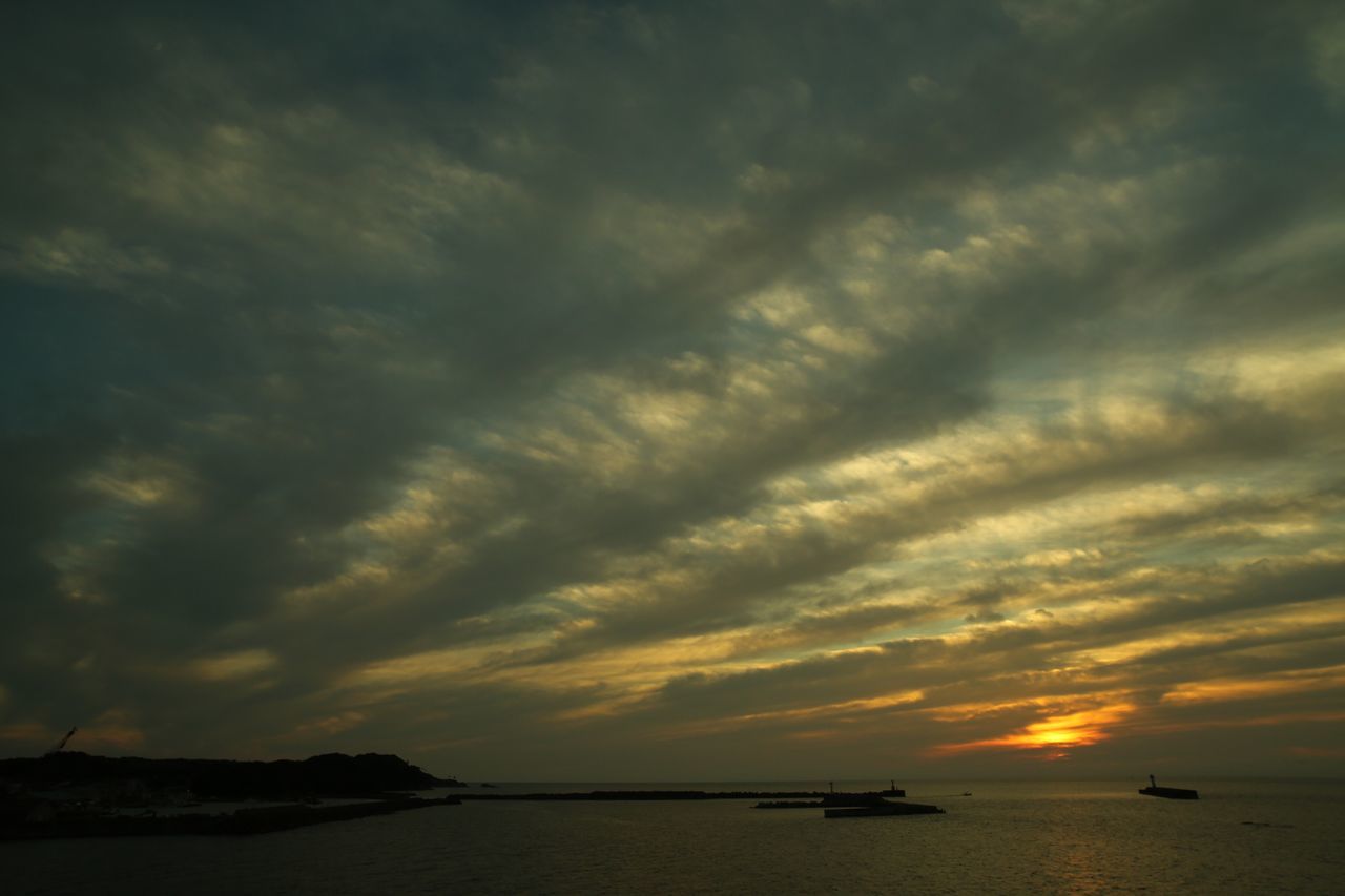 sea, water, sunset, sky, scenics, tranquil scene, tranquility, horizon over water, beauty in nature, cloud - sky, nature, idyllic, cloudy, cloud, orange color, dramatic sky, outdoors, calm, no people, moody sky, majestic, remote, overcast, non-urban scene, weather, ocean, seascape, cloudscape