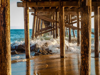 Wooden pier on sea against sky