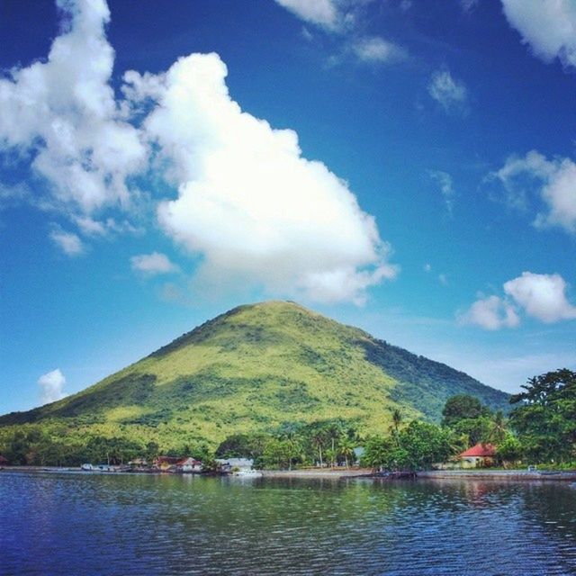 mountain, water, sky, mountain range, tranquil scene, tranquility, scenics, lake, cloud - sky, beauty in nature, waterfront, cloud, tree, nature, blue, transportation, river, nautical vessel, idyllic, day