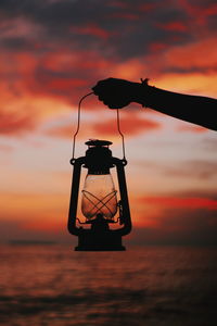 Silhouette ship on sea against sky during sunset