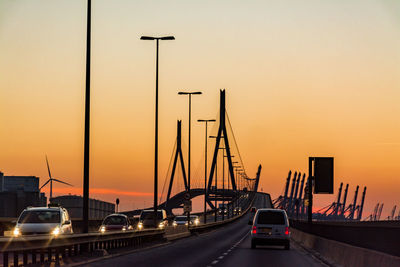 Traffic on road at sunset