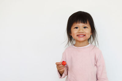 Portrait of a smiling girl over white background