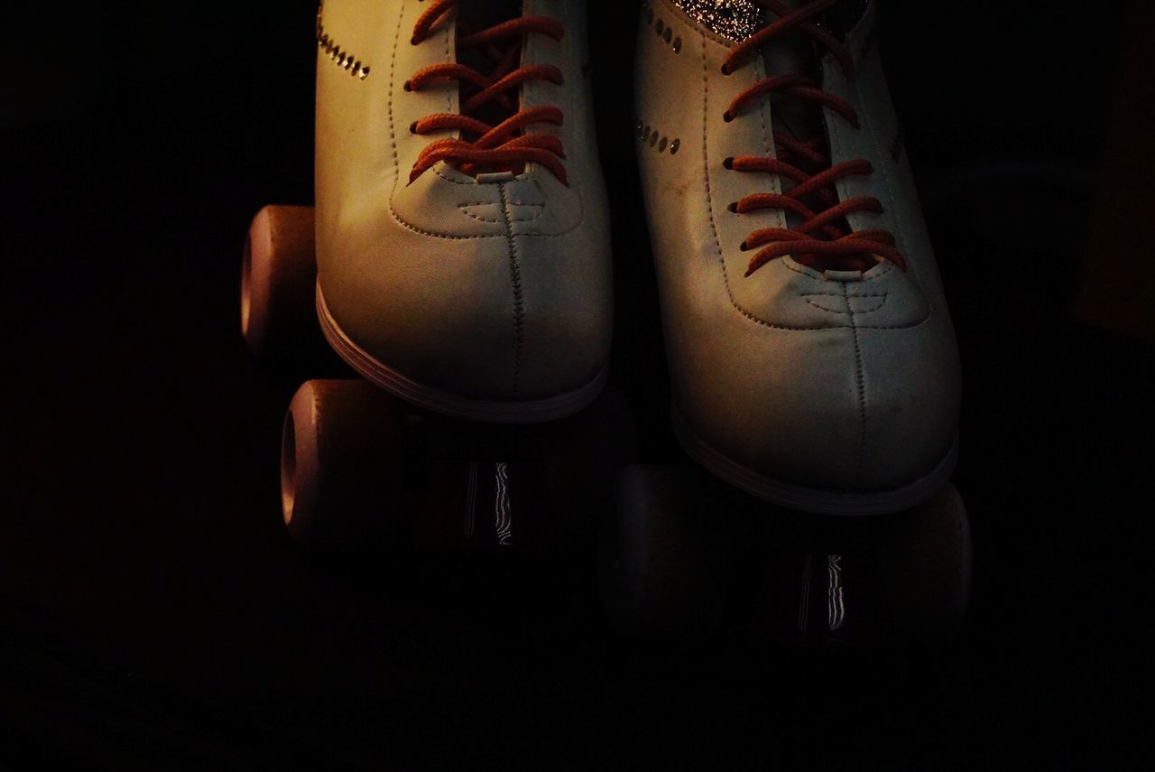 HIGH ANGLE VIEW OF SHOES ON FLOOR IN DARK ROOM