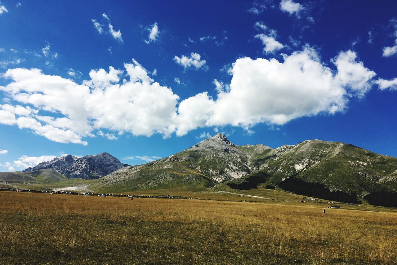 SCENIC VIEW OF MOUNTAINS AGAINST CLOUDY SKY