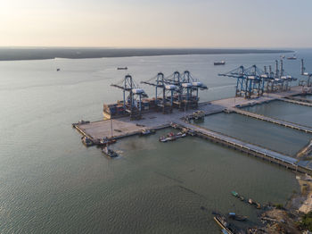 High angle view of commercial dock by sea against sky