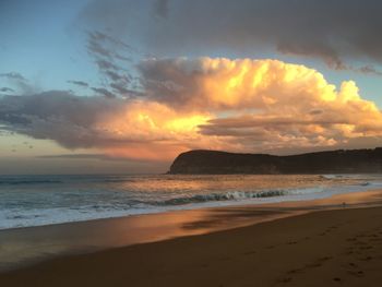 Scenic view of beach against sky during sunset