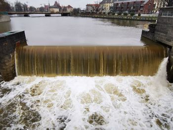 Scenic view of river flowing through dam