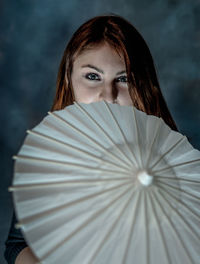 Portrait of woman with drink umbrella