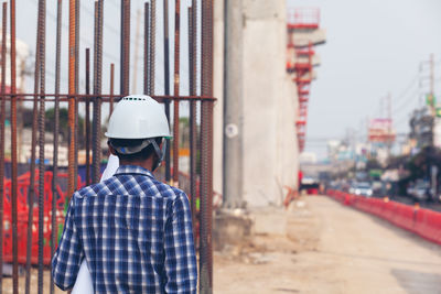 Rear view of man working at construction site