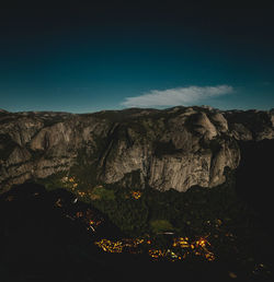 Scenic view of illuminated mountains against sky at night