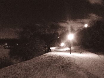 View of illuminated street lights at night