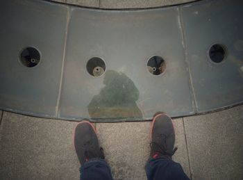 Low section of man wearing shoes