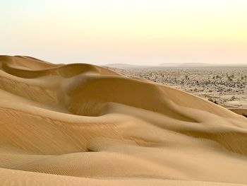 Scenic view of desert against sky during sunset