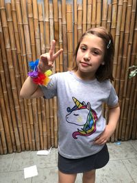 Portrait of innocent girl showing peace sign