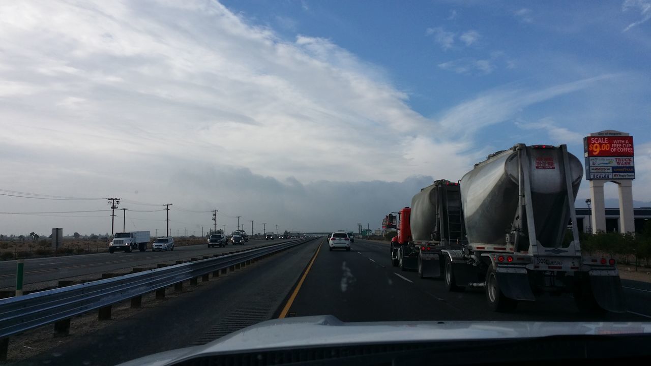 transportation, mode of transport, sky, the way forward, road, built structure, cloud - sky, car, building exterior, architecture, diminishing perspective, land vehicle, road marking, vanishing point, day, cloud, travel, public transportation, no people, cloudy