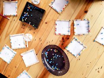 High angle view of multi colored pencils on hardwood floor