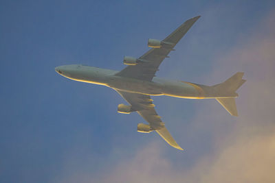 Low angle view of airplane flying against clear sky