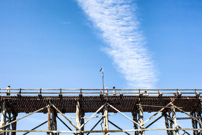 Low angle view of bridge against blue sky