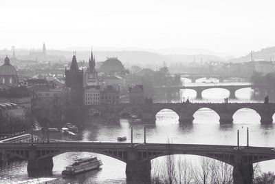 Bridge over river with buildings in background